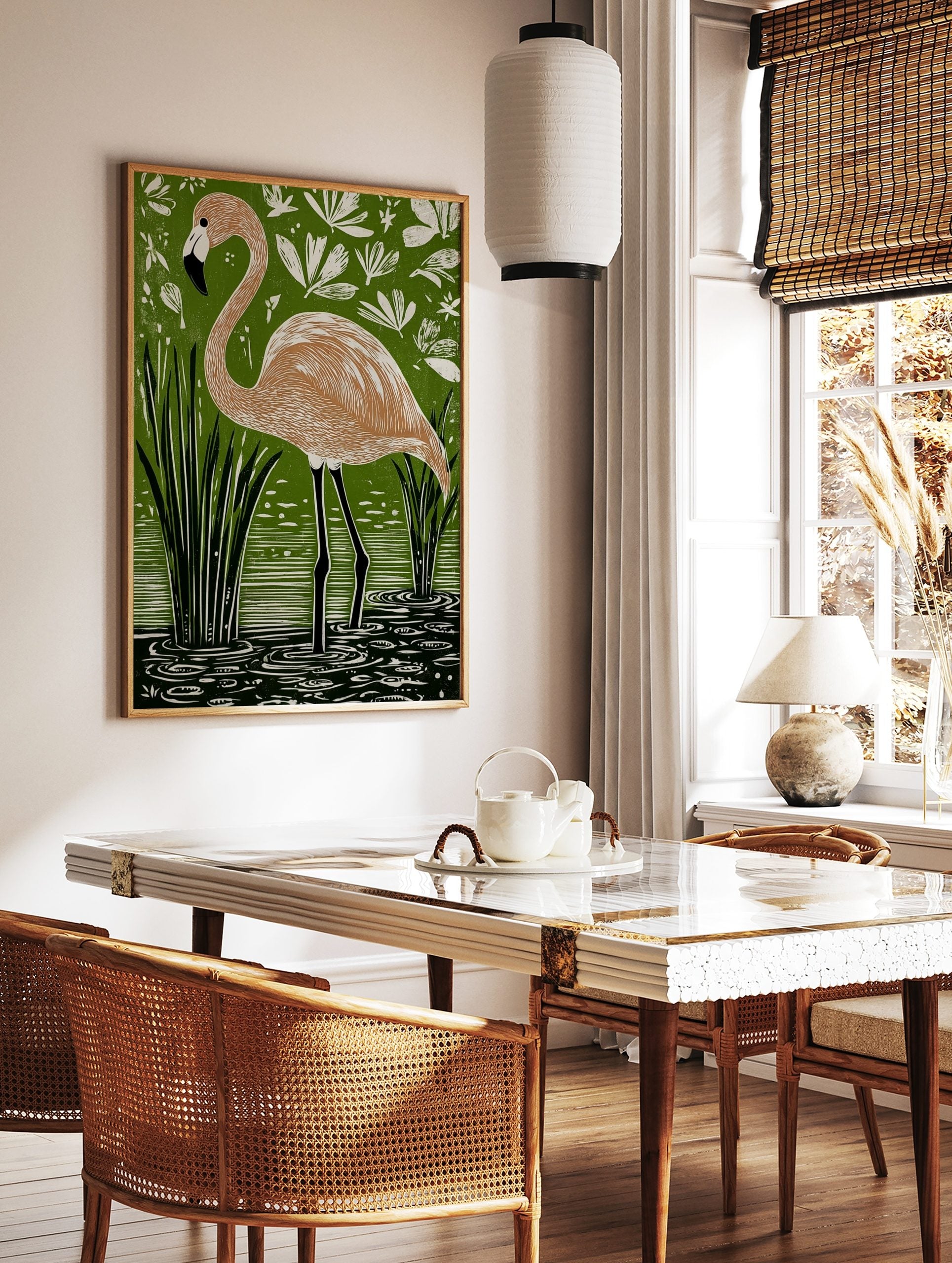 Linocut style art print of a flamingo standing in green water with reeds and white tropical foliage, in a styled room mockup