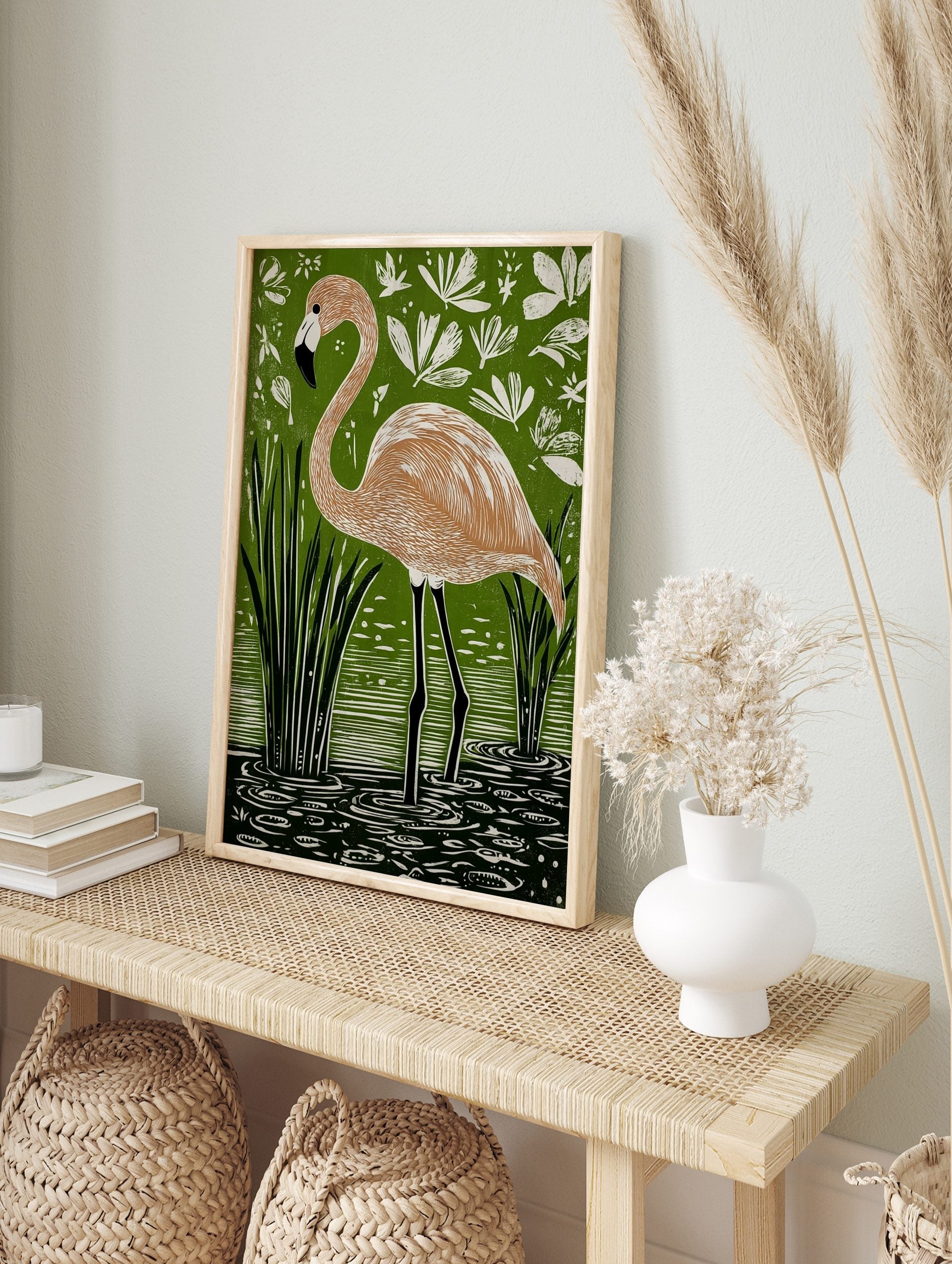 Flamingo bird art print in green water with reeds and white leaves, peach and black colours, in an alternate framed mockup