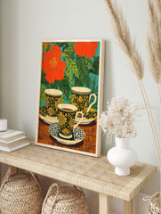 Floral tea cups poster with red flowers, green leaves, and black and yellow patterned cups on a wooden table. - Image 4