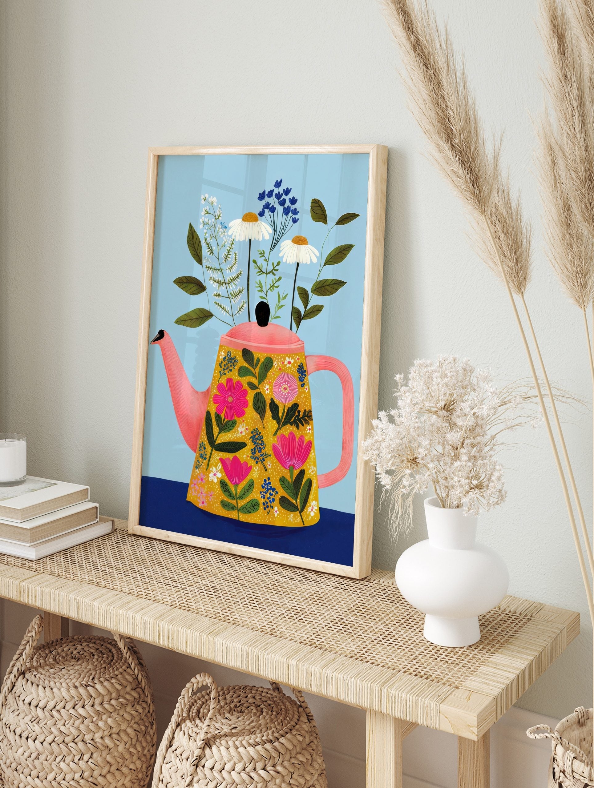 Illustrative print of a floral teapot with pink, white, and blue flowers, green leaves, on light blue background, in an