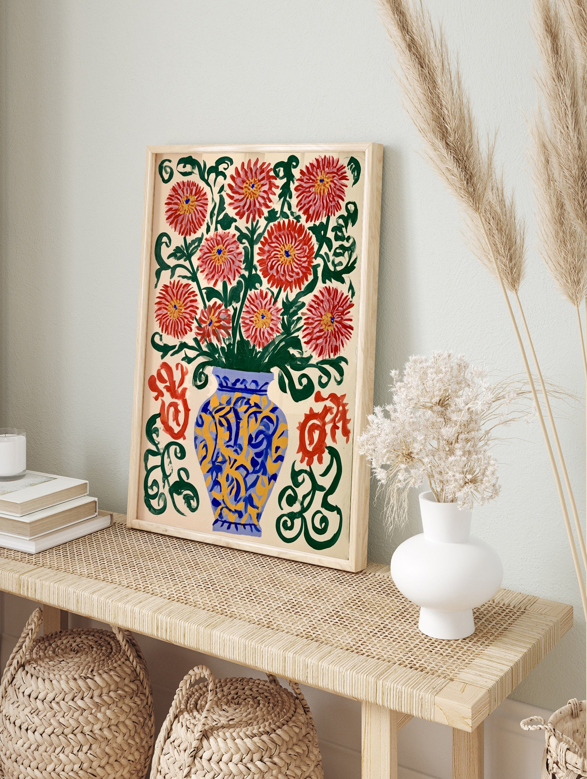 Illustrative red chrysanthemum flowers in a blue and yellow vase with green swirls on a cream, in an alternate framed mockup