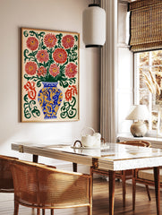 Illustrative red chrysanthemum flowers in a blue and yellow vase with green swirls on a cream, in a styled room mockup