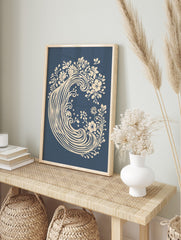 Cream floral wave botanical art print on a deep blue background, unframed, in an alternate framed mockup