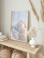 Close-up of fluffy white and pale orange clouds against a light blue sky, creating a serene, in an alternate framed mockup