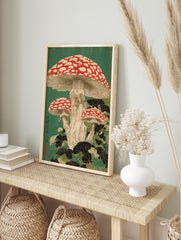 Japanese woodblock print of three red and white spotted fly agaric mushrooms with dark green, in an alternate framed mockup