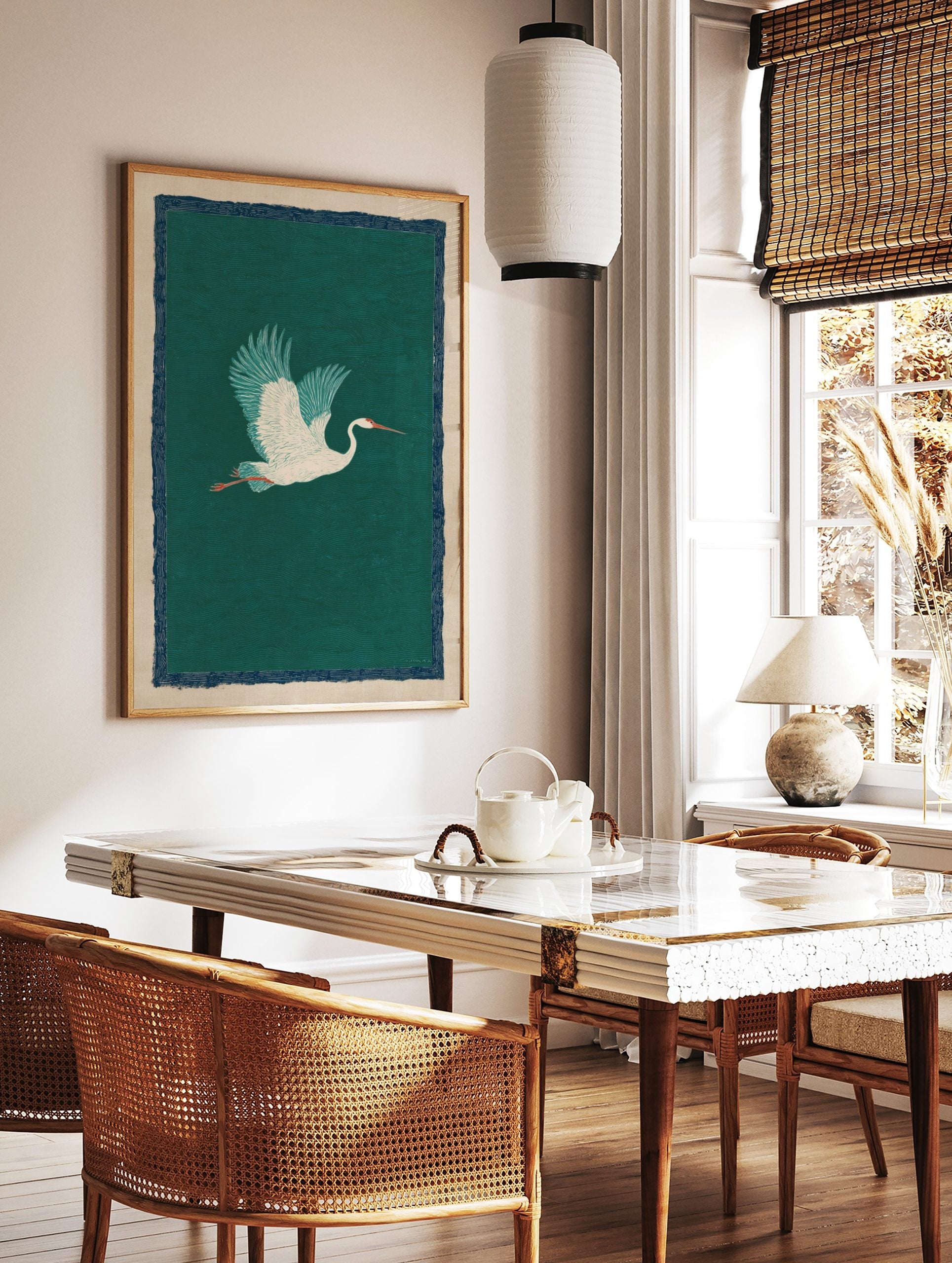 White crane bird with teal wings flying against a deep green wave-patterned background, with a navy, in a styled room mockup