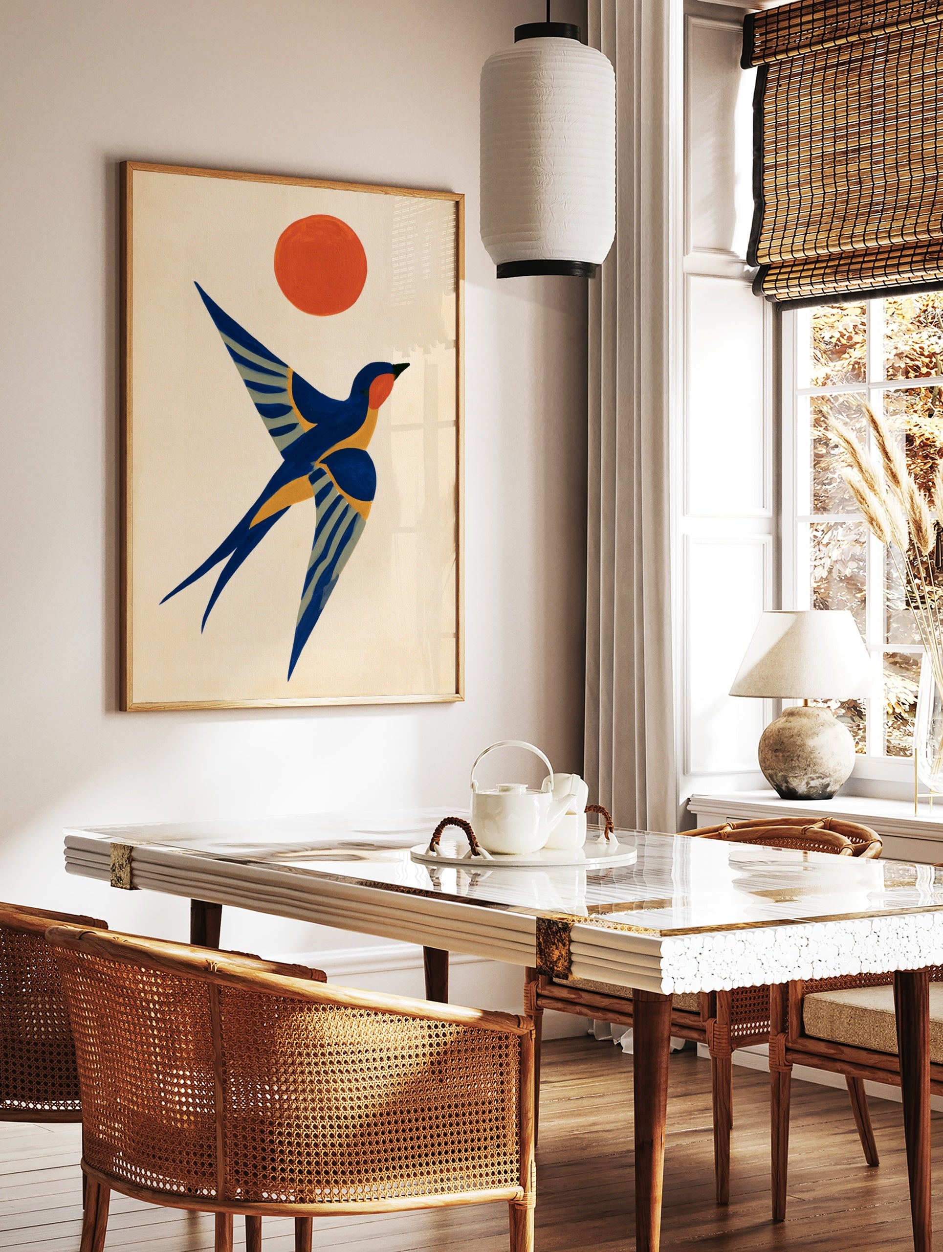 Stylised swallow bird in flight with an orange sun in a graphic, illustrative art style on a cream, in a styled room mockup