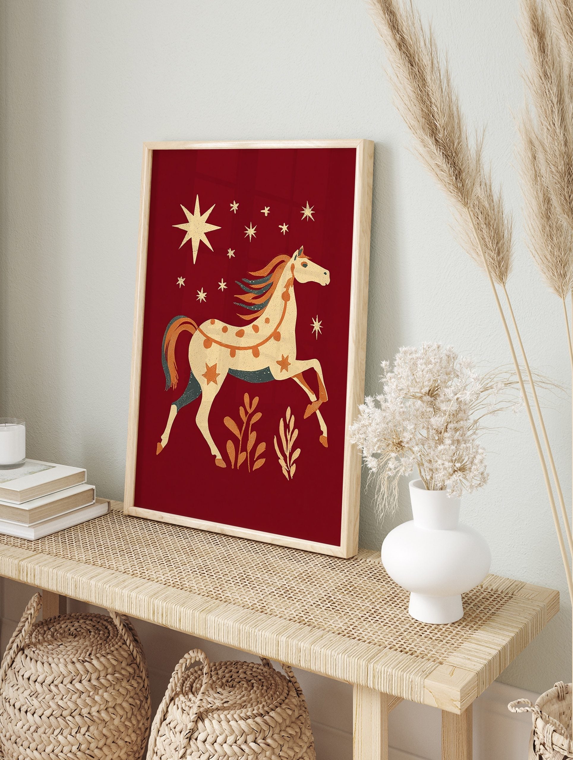 Folk art horse wall art print with orange dots, stars, and teal mane on a deep red background, in an alternate framed mockup