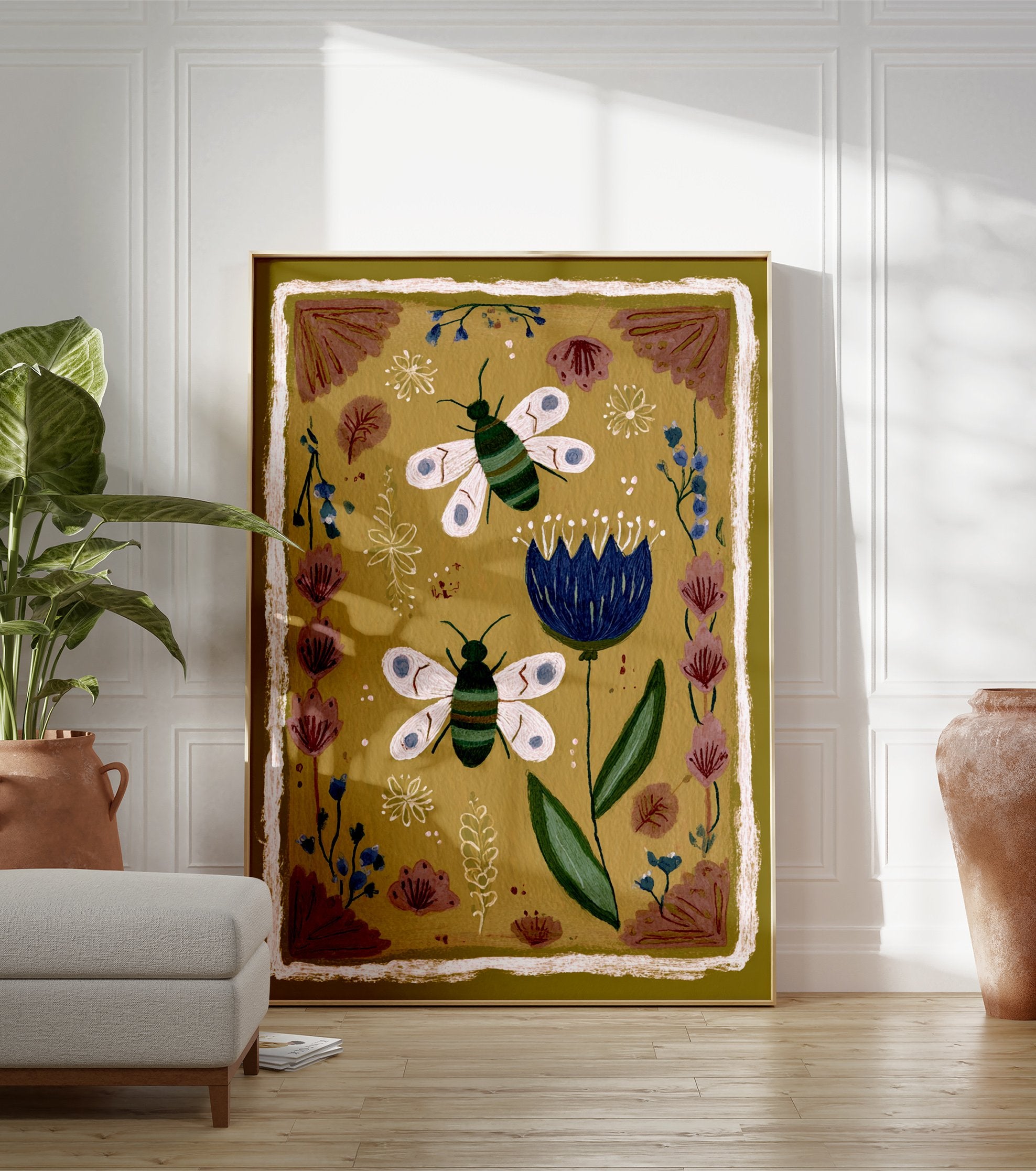 Folk art illustration of two striped bees and a blue flower on an olive green background with a rustic border - Image 3