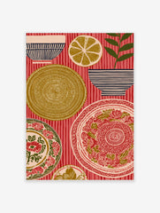 Folk art print of ornate plates, striped bowls, a lemon slice, and a plant on a red striped background