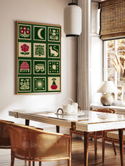 Folk art style stamp grid print featuring botanical flowers, celestial moons, and animals on a deep, in a styled room mockup