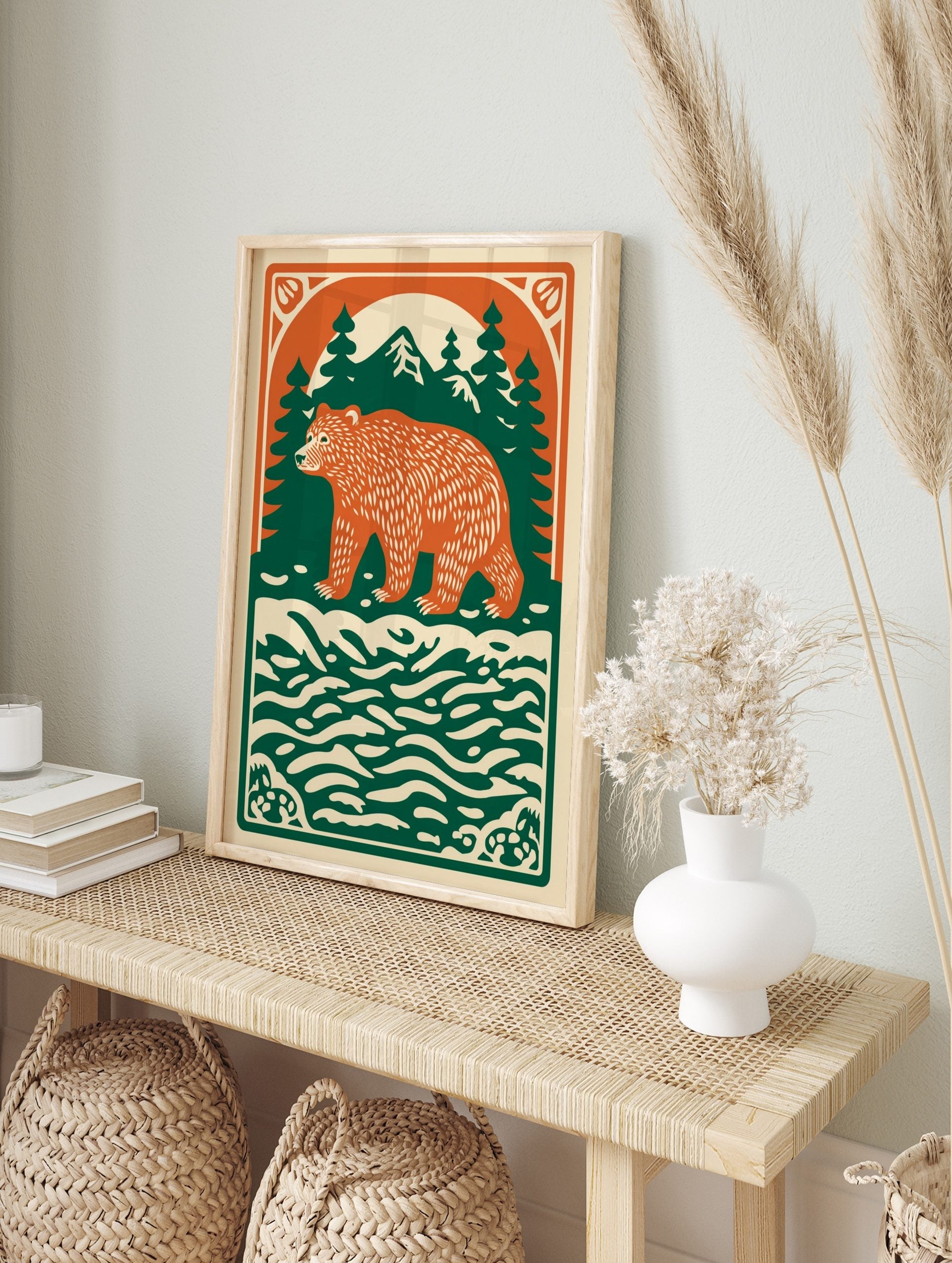 Illustrative forest bear print with orange bear, green pine trees, mountains, and cream water, in an alternate framed mockup
