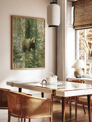 Brown bear standing among green pine trees with a patterned patchwork background in muted green and, in a styled room mockup