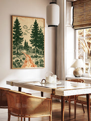 Illustrative forest scene with a log cabin, green pine trees, orange path, and cream sky, in a styled room mockup