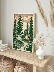 Illustrative forest scene with tall pine trees, a red and cream striped tent, a path, and a, in an alternate framed mockup