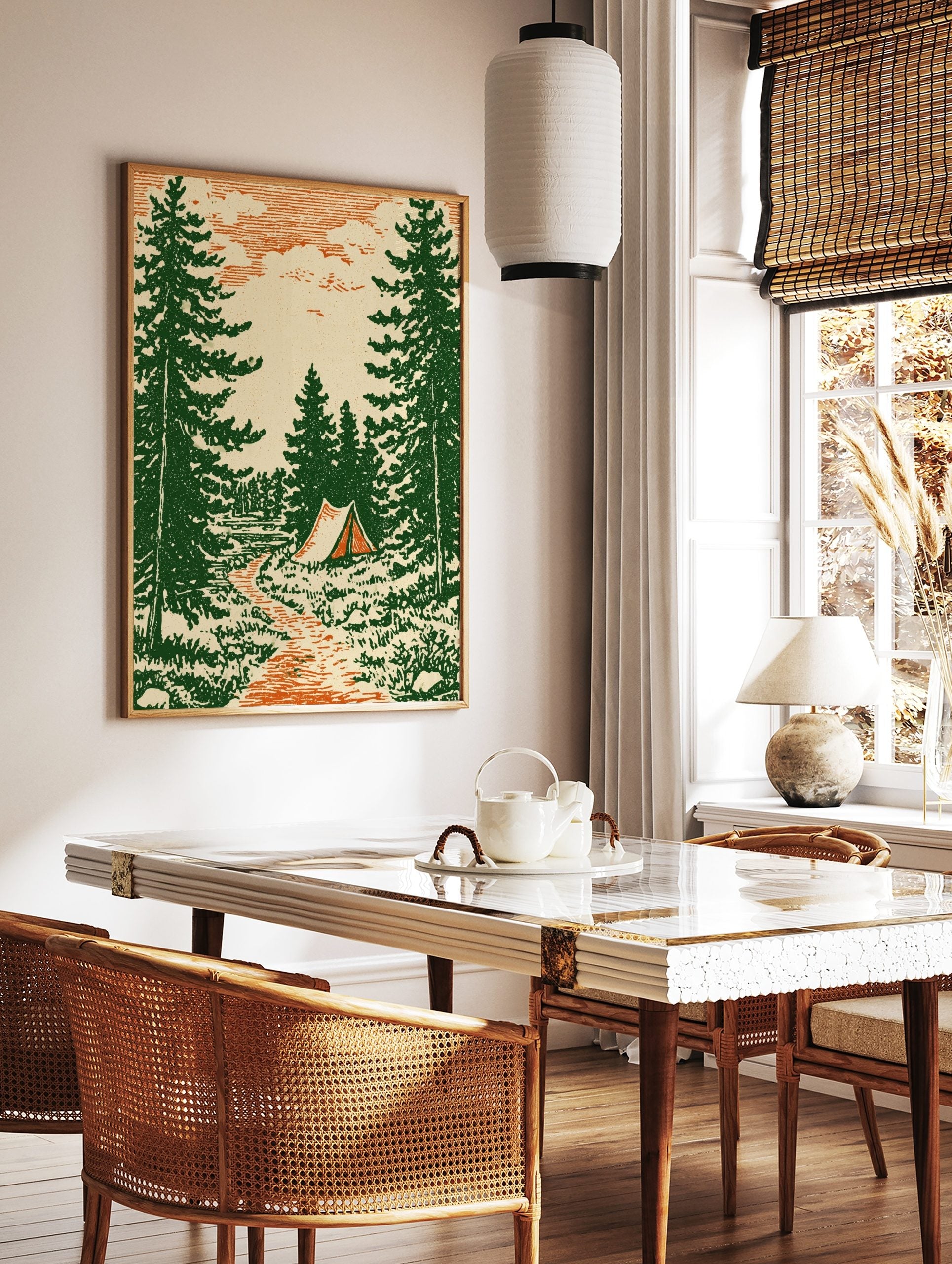 Vintage illustrative print of a forest camping scene with pine trees, a path, and a tent by water, in a styled room mockup