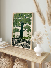 Linocut style art print of a green fox walking under a large oak tree with moss and mushrooms, in an alternate framed mockup