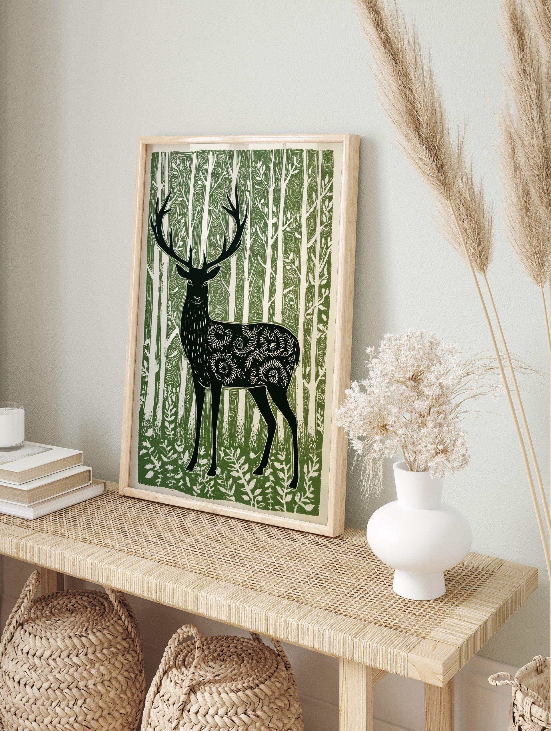 Illustrative green and white print of a forest stag with ornate body patterns amidst tall, in an alternate framed mockup