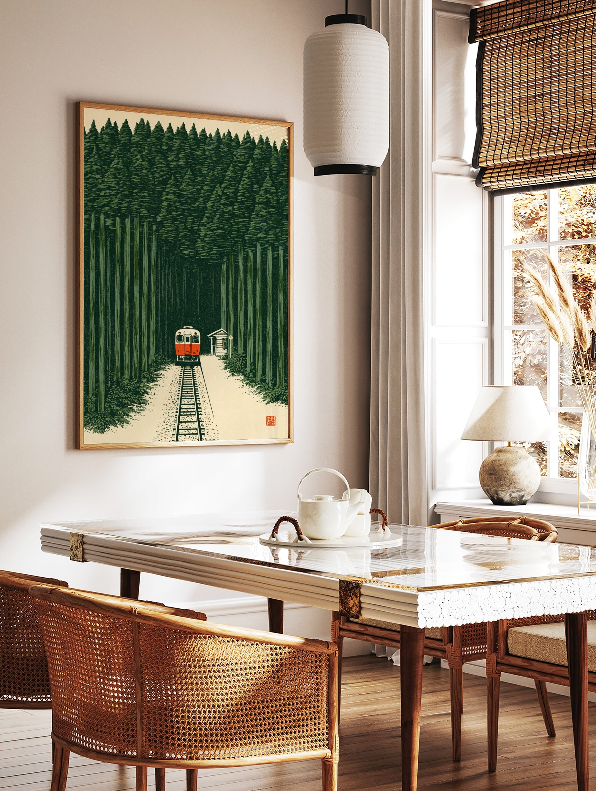 Illustrative art print of a red train travelling through a dense green forest with a small station, in a styled room mockup