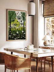 Green and black linocut style print of a forest with trees, tall wildflowers, and butterflies, in a styled room mockup