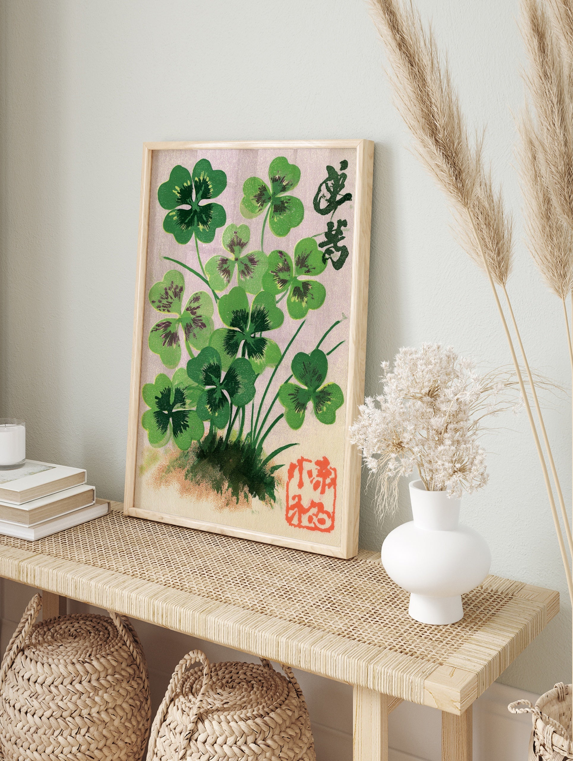 Botanical illustration of four-leaf clovers with Japanese calligraphy and a red seal stamp on, in an alternate framed mockup