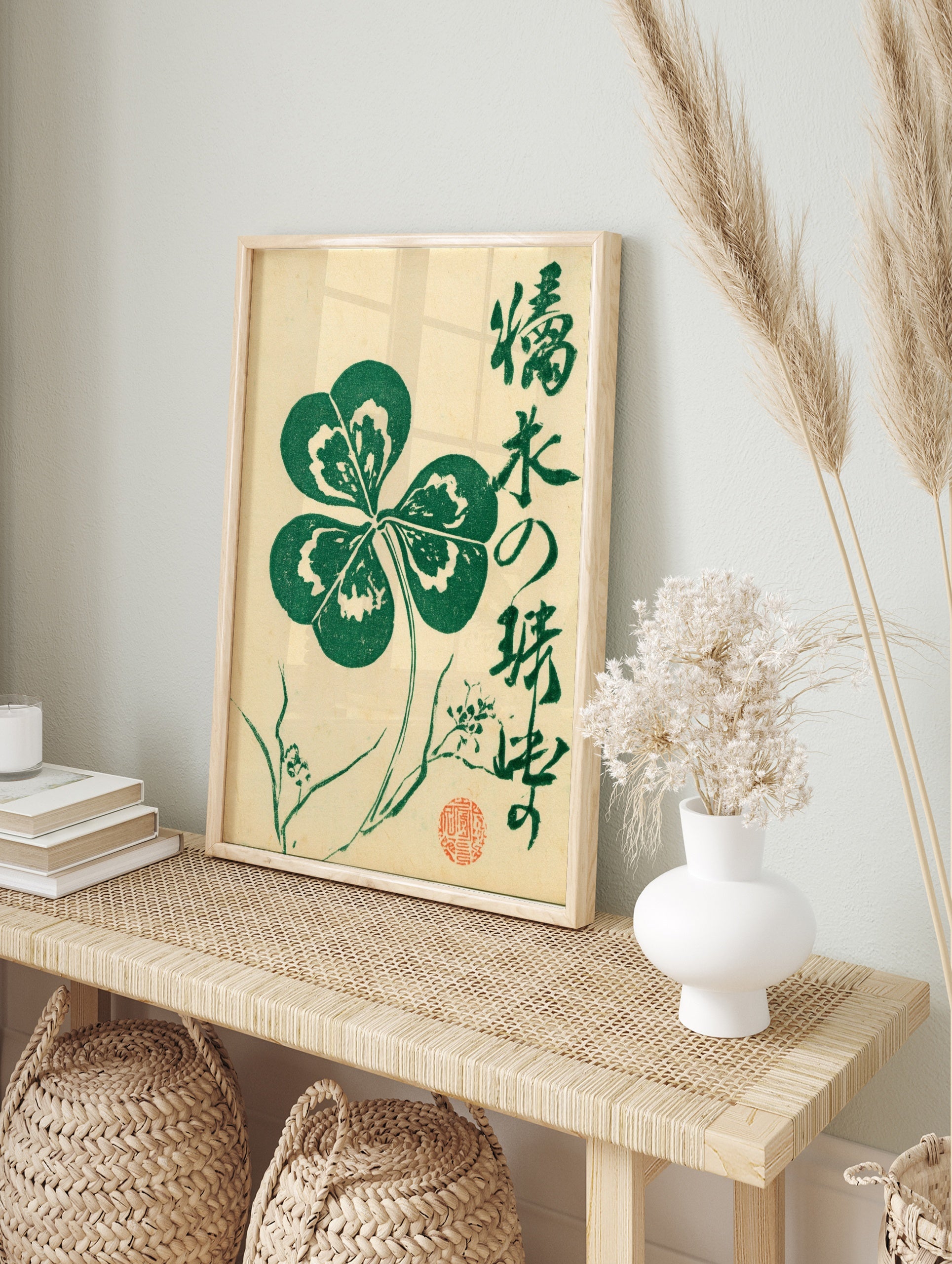 Four-leaf clover botanical illustration with Japanese calligraphy and red seal on cream paper, in an alternate framed mockup