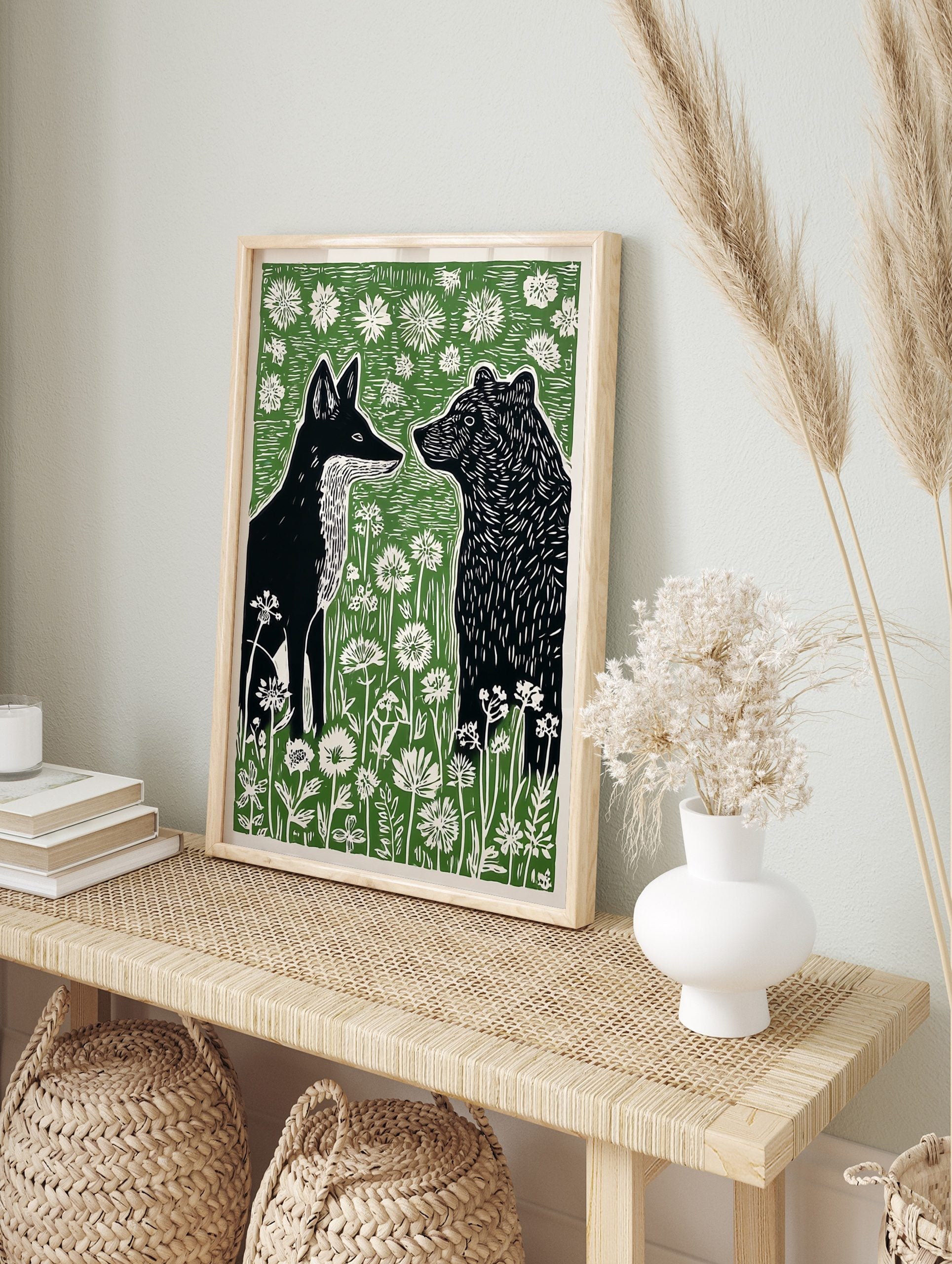 Black fox and bear in profile, surrounded by white wildflowers and green foliage, in a, in an alternate framed mockup