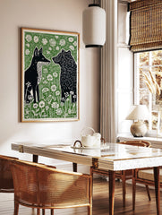 Black fox and bear in profile, surrounded by white wildflowers and green foliage, in a linocut art, in a styled room mockup