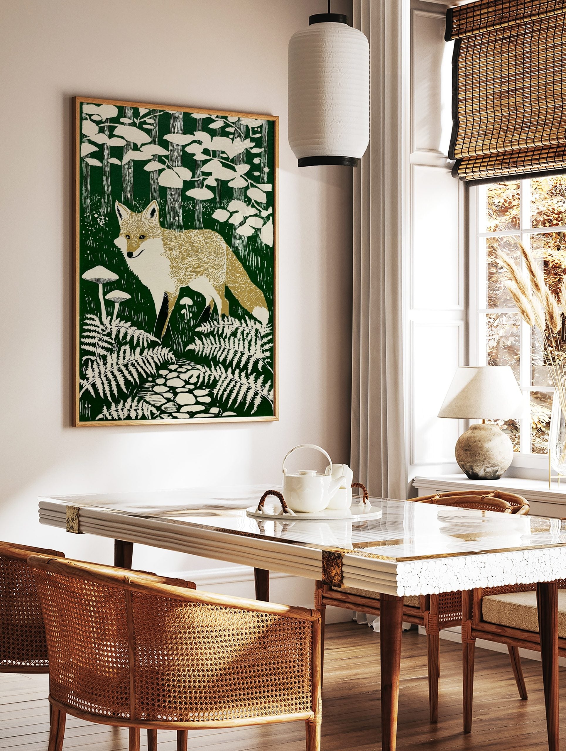 Illustrative fox print in a dark green forest with beige ferns, mushrooms, trees, and a stone path, in a styled room mockup