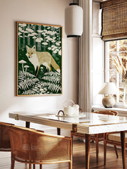 Illustrative fox print in a dark green forest with beige ferns, mushrooms, trees, and a stone path, in a styled room mockup