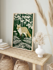 Linocut style art print of a golden-tan fox standing among white ferns and mushrooms in a, in an alternate framed mockup