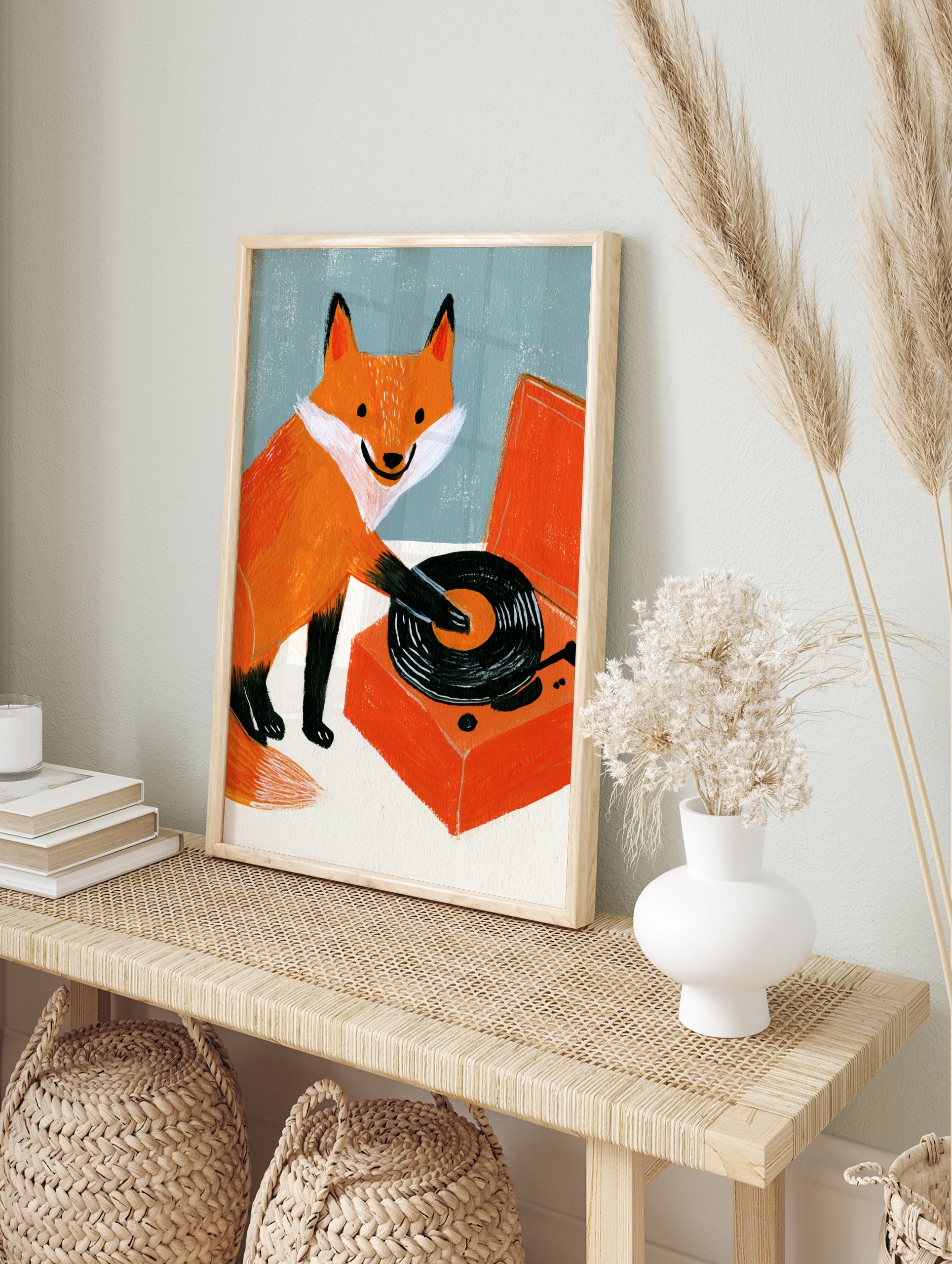 Illustration of an orange fox playing a black vinyl record on an orange turntable against a, in an alternate framed mockup