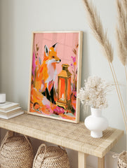 Illustrative fox sitting next to a glowing lantern with colourful abstract flowers, pink and, in an alternate framed mockup