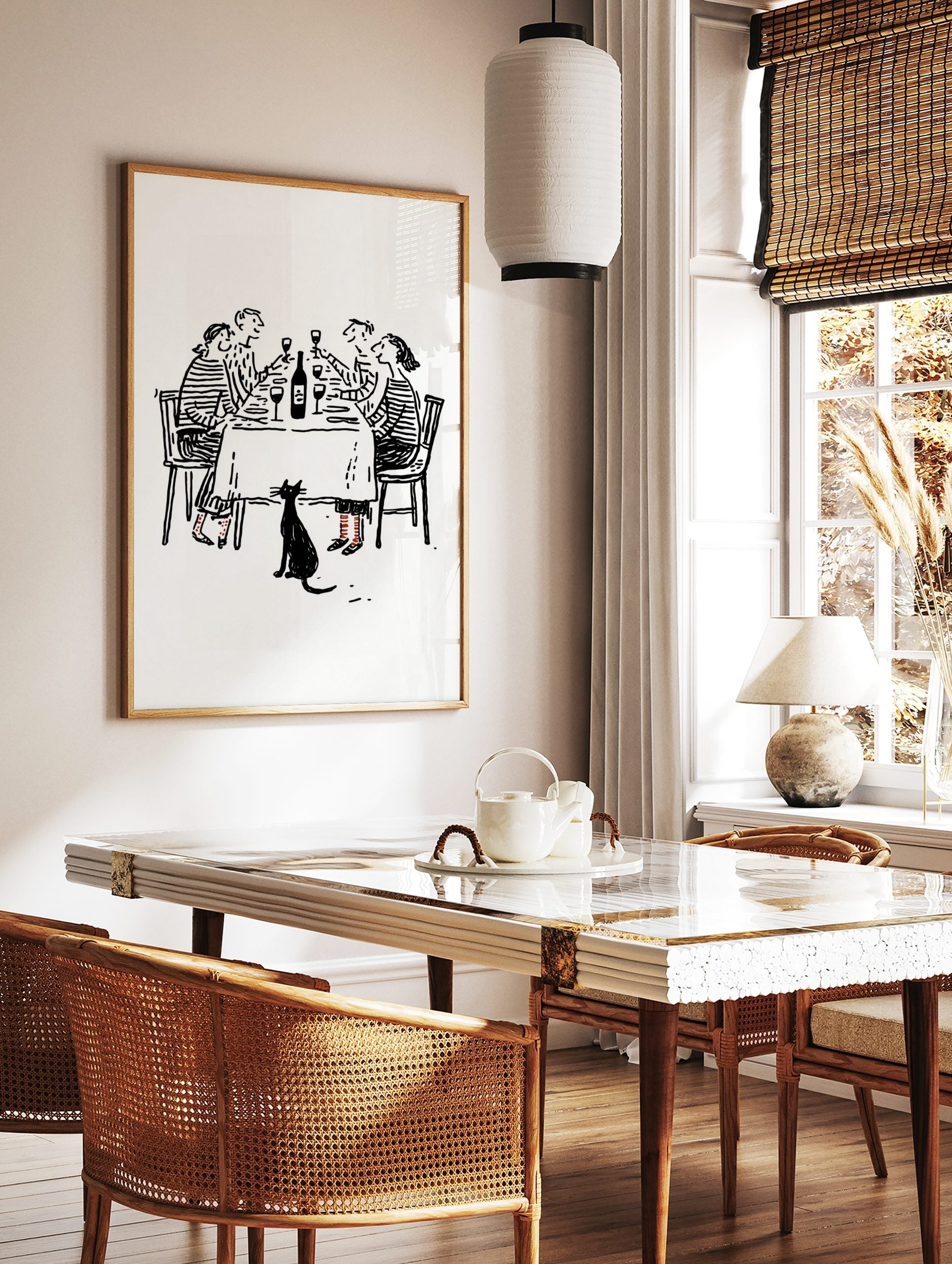 Black and white line drawing of four friends at a dinner party with a black cat below the table, in a styled room mockup