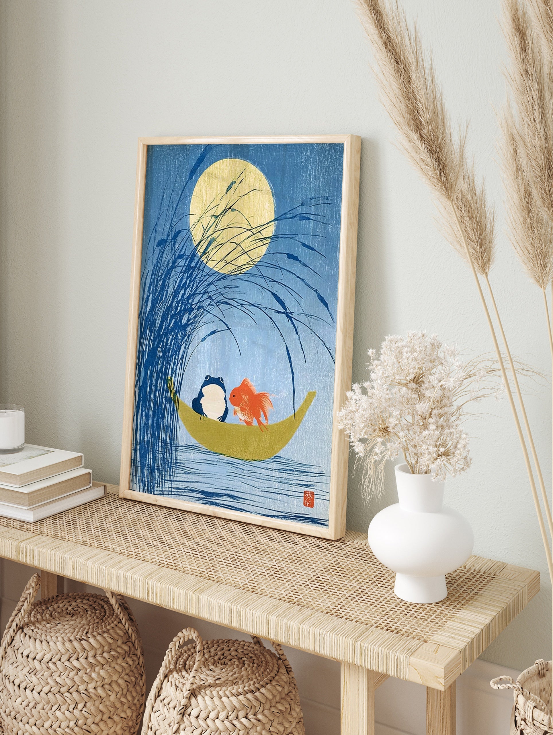 Blue frog and orange goldfish in a crescent moon boat under a full moon in a Japanese style, in an alternate framed mockup