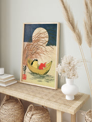 Japanese style art print of a frog and goldfish in a crescent moon boat with tall grass and a, in an alternate framed mockup