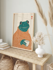Whimsical frog art print featuring a green frog wearing an orange turtleneck sweater and holding a white cup on an off-white background. - Image 3
