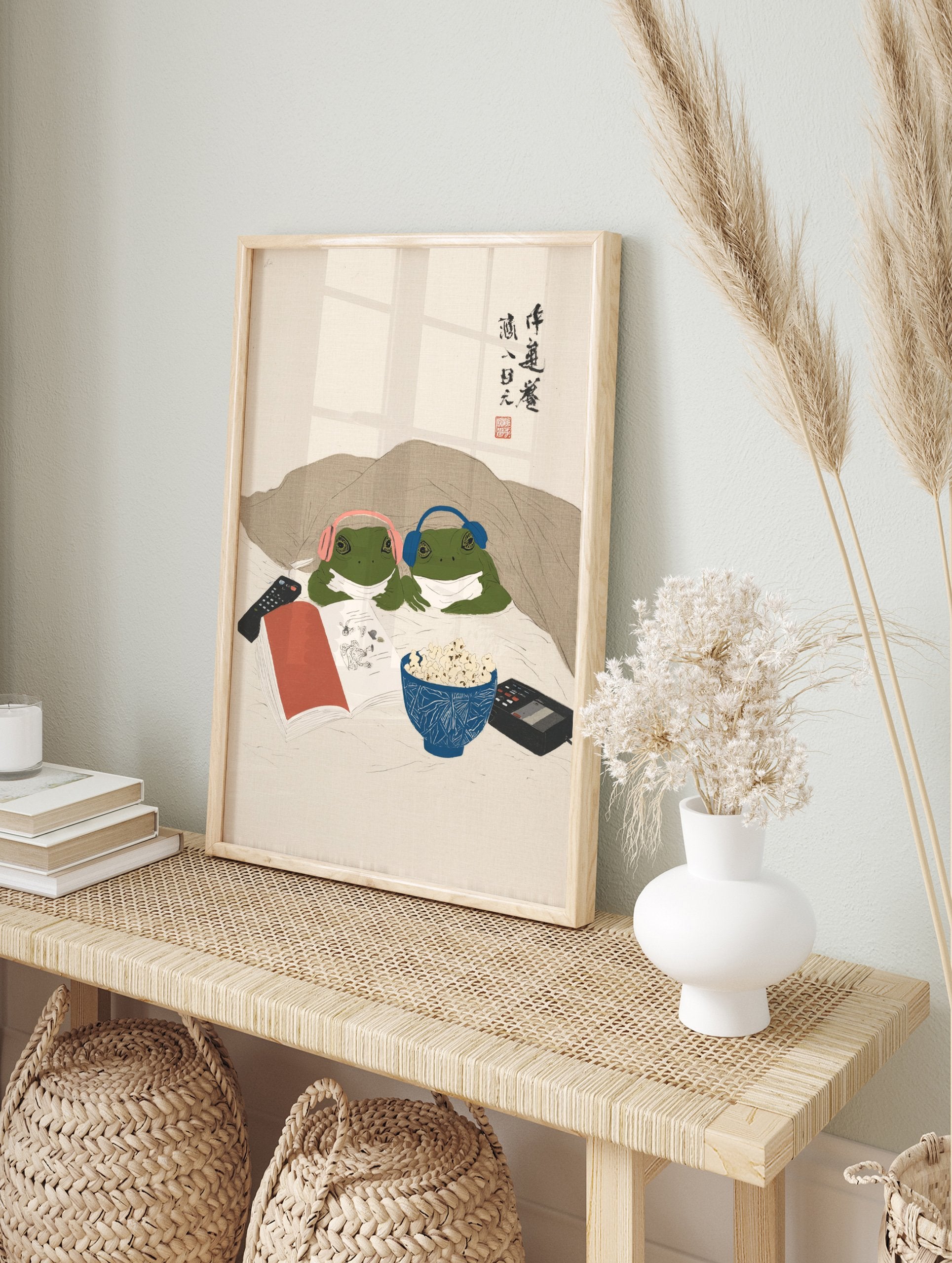 Humorous frog art print of two green frogs in headphones under a blanket, watching a movie with popcorn and a remote. - Image 3