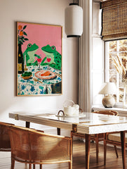 Whimsical painting of two green frogs on a dinner date with wine and food, against a pink background, in a styled room mockup