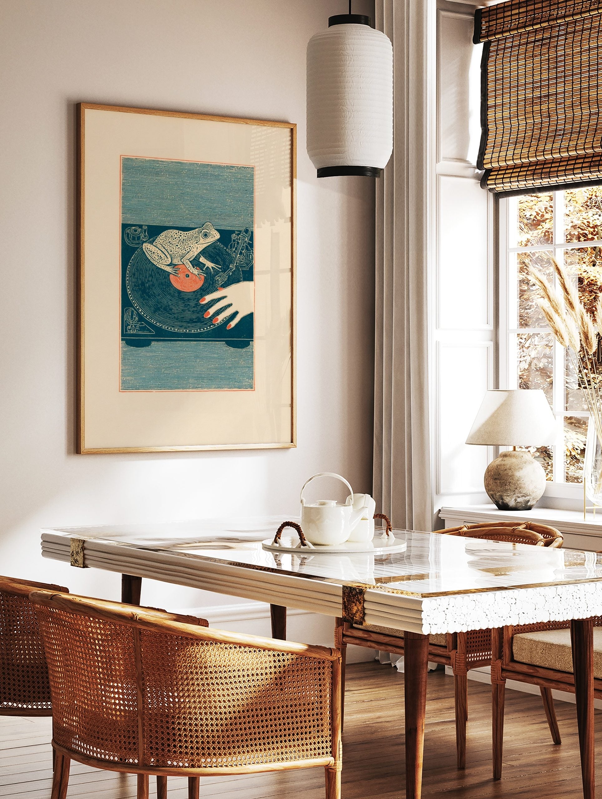 Illustrative frog DJ wall art on a turntable with a vinyl record and human hand, in a styled room mockup