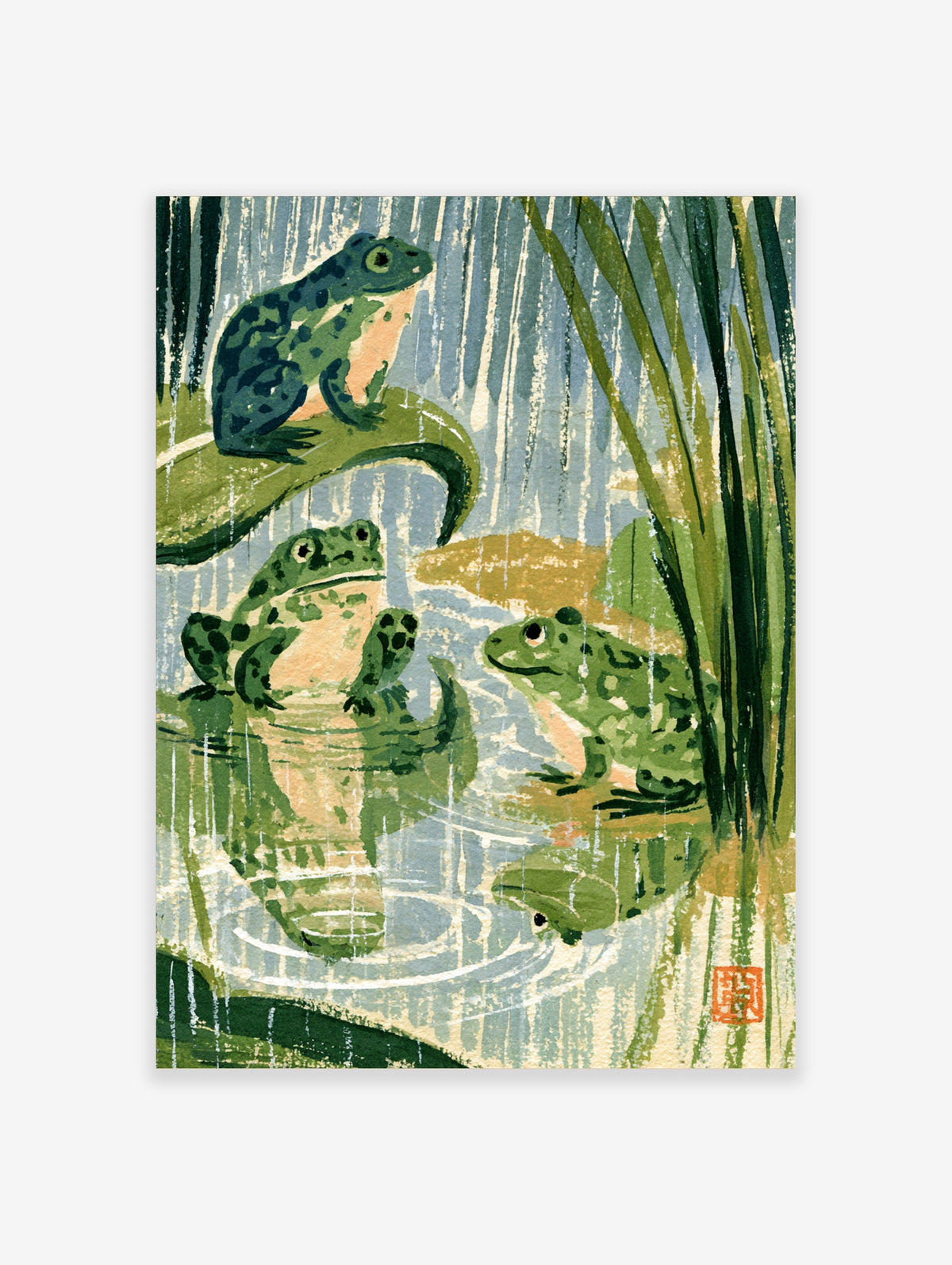 Japanese woodblock frog art print with three green frogs on lily pads in blue-grey rain and reeds