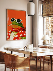 Illustration of a frog wearing sunglasses and a red polka-dot suit, smoking, against a bright, in a styled room mockup