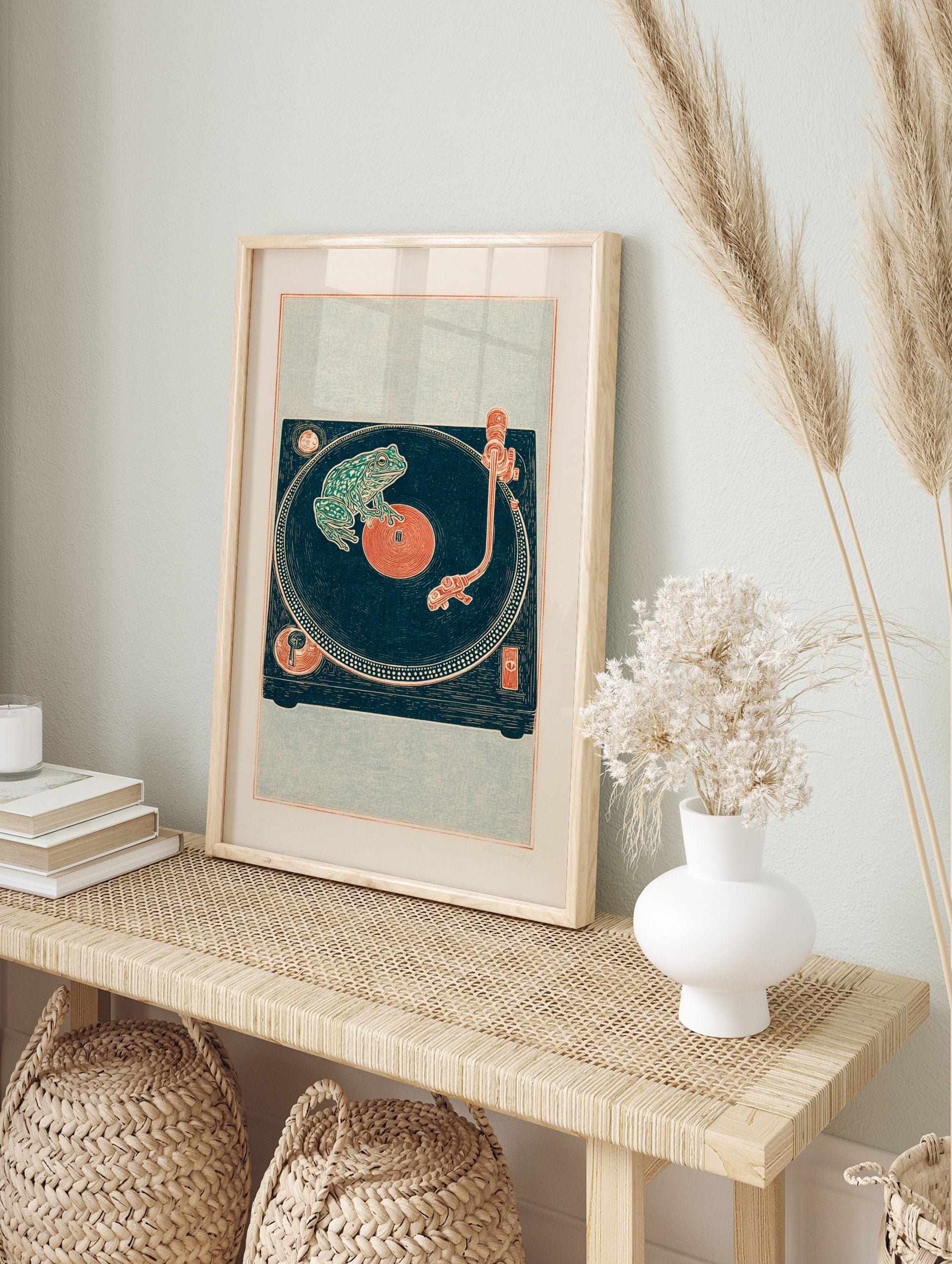 Illustrative green frog on a deep teal vinyl record and turntable art print with, in an alternate framed mockup
