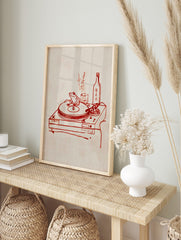 Red line art of a frog on a turntable, with a sake bottle, glass, and Japanese text on a, in an alternate framed mockup