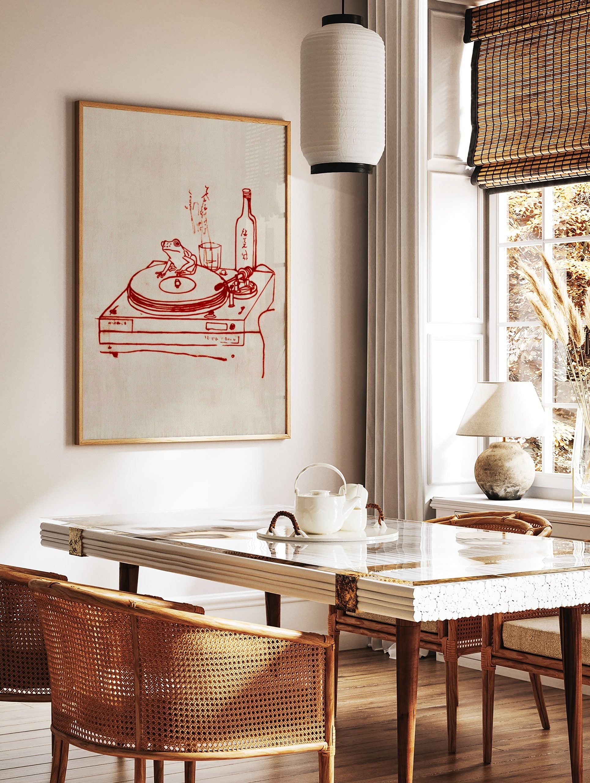 Red line art of a frog on a turntable, with a sake bottle, glass, and Japanese text on a light, in a styled room mockup