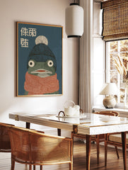 Illustrative frog wall art wearing a blue beanie and orange scarf with Japanese text on a dark blue background, cozy animal print. - Image 2