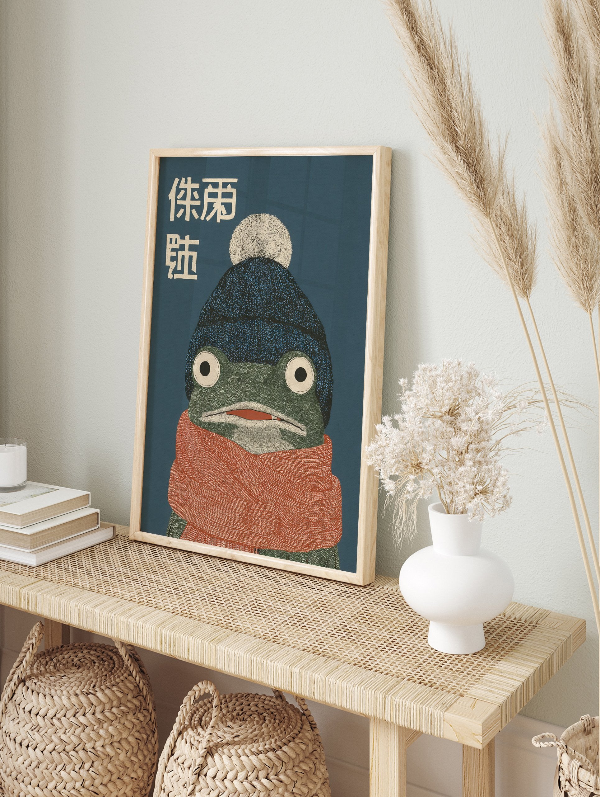 Illustrative frog wall art wearing a blue beanie and orange scarf with Japanese text on a dark blue background, cozy animal print. - Image 3