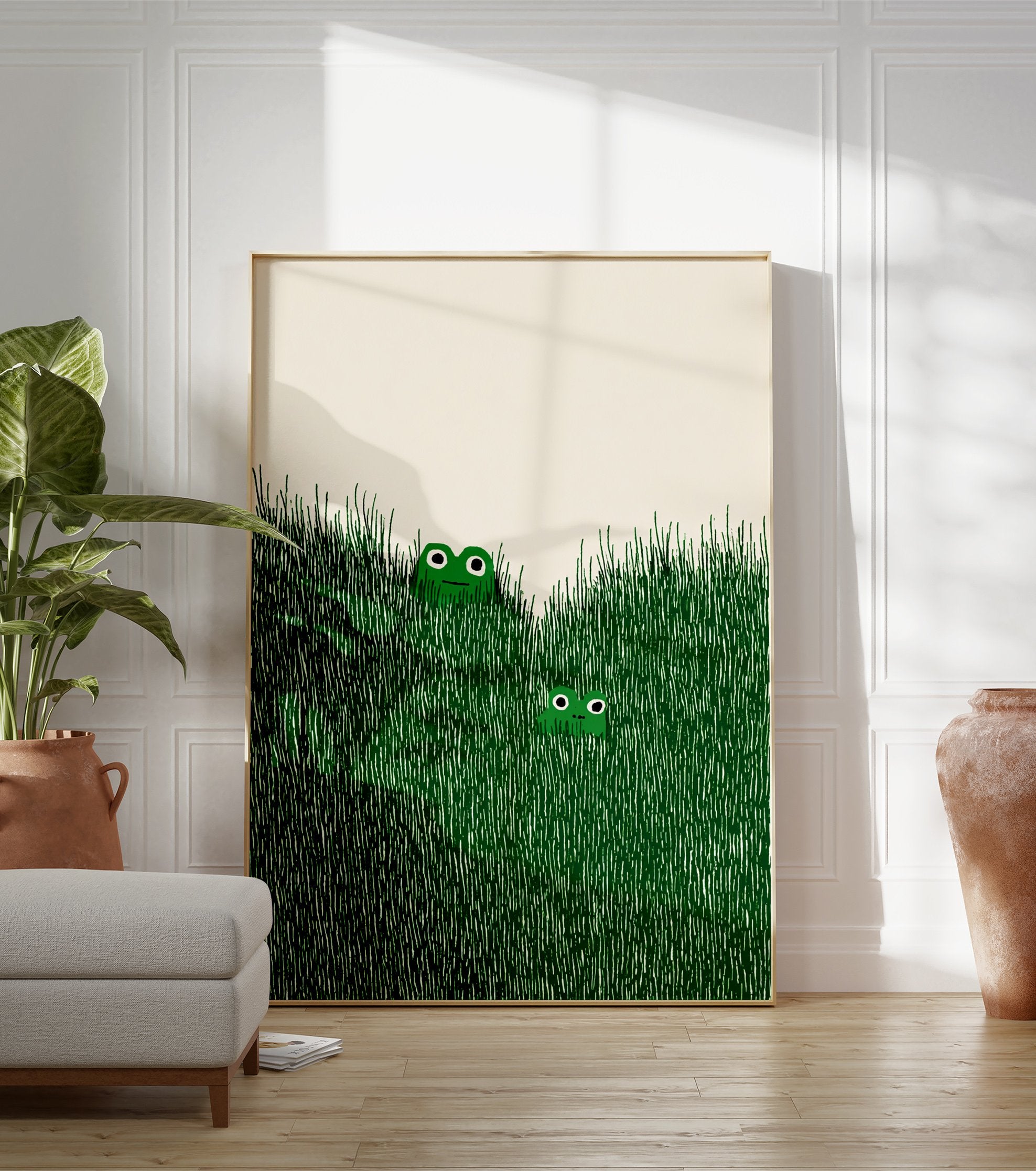 Illustrated frog wall art with two green frogs peeking out of tall green grass on an off-white background. - Image 3