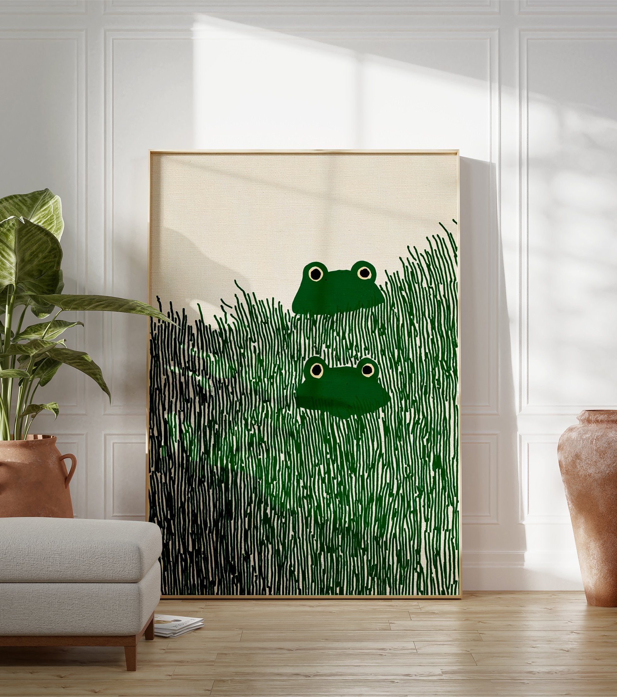 Illustrative frog wall art print featuring two green frogs with black eyes peeking from tall dark green grass. - Image 3