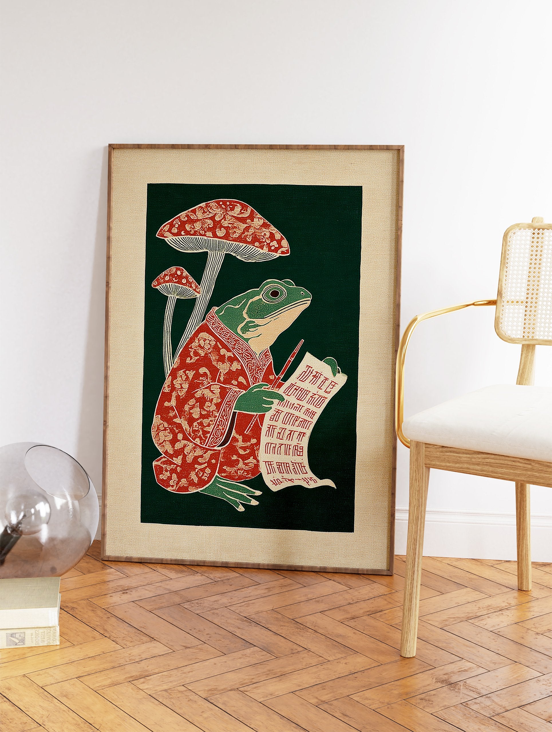 Illustrative frog in a red robe writing on a scroll next to red mushrooms against a dark green background, folk art print. - Image 2
